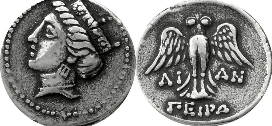 Silver coin showing Tyche on the obverse and an eagle on the reverse